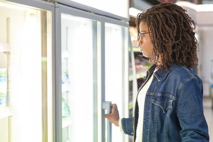 1 young-black-female-customer-studying-fridge-shelves_74855-3353