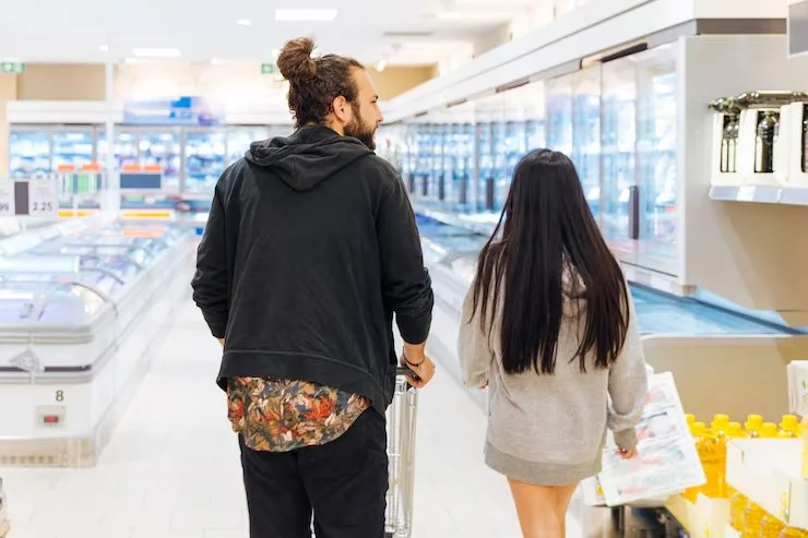 young-couple-shopping-supermarket_23-2148150037