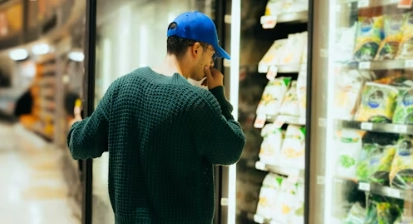 a person shops for frozen foods